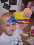 Gregory playing with a train