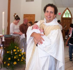 Frank holding Aidan after his baptism