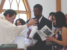Tre is sealed in baptism with the sign of the cross