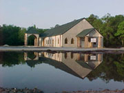 church reflected in a full retention pond