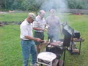 Gil Neil and Mike cooking burgers and dogs