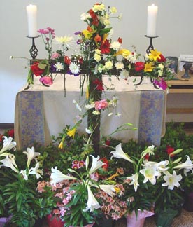 Flowered cross in front of altar