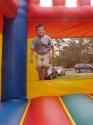 Logan jumping on the moon bounce