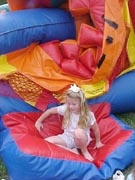 Madison in front of a deflating moon bounce