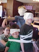 Group photo of kids bound in bandages
