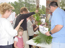 The congregation selects palm branches to carry