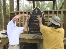 Scott and Kenn attach the memorial plaque