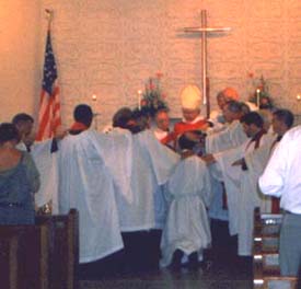 Bishop Louttit and priests laying hands on Frank Logue during his ordination