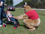 Pooh greets a baby at the picnic